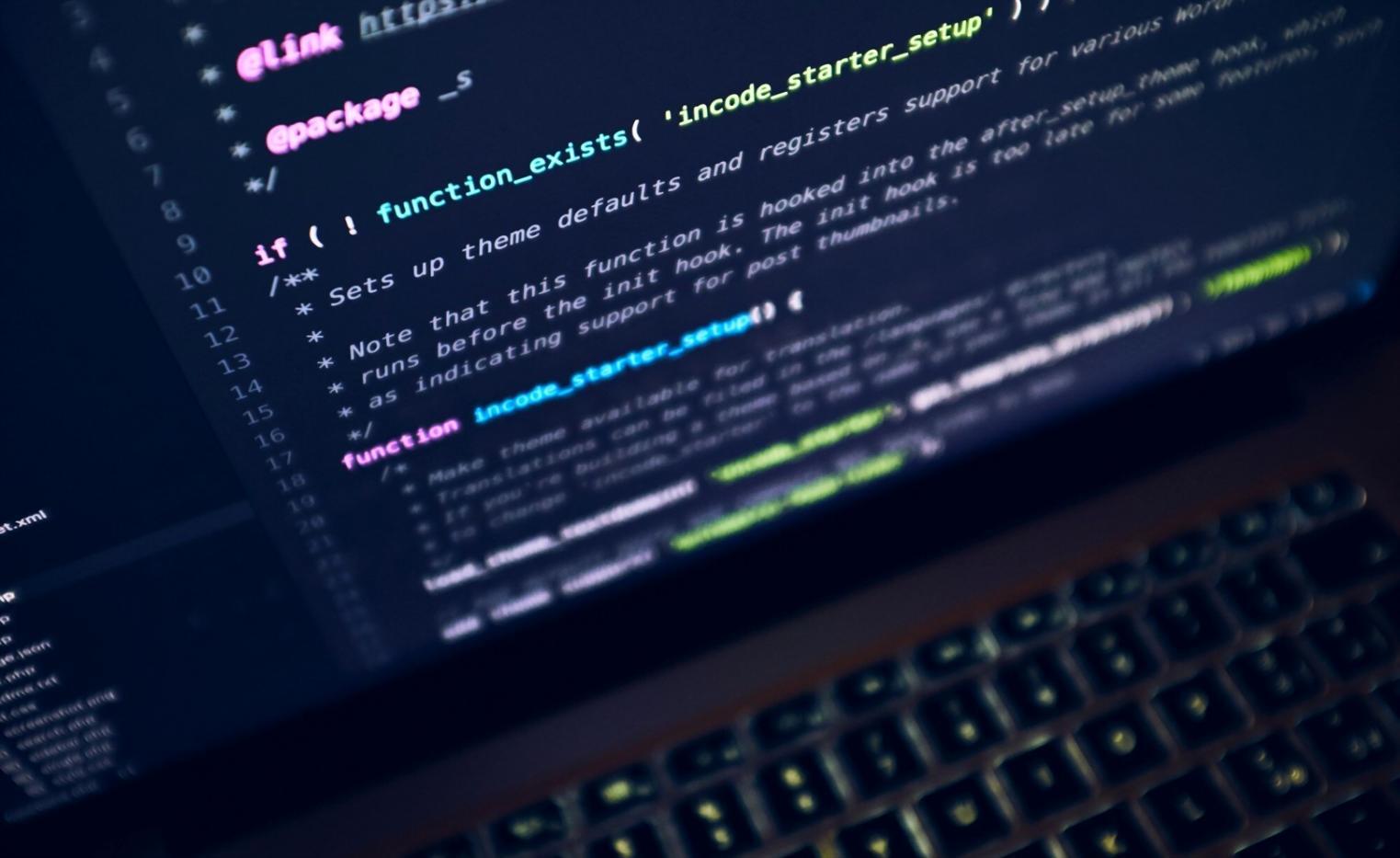 Database development workspace showing multiple monitors with code and database schemas